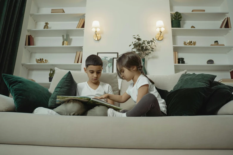 a couple of kids sitting on top of a couch, pexels contest winner, diseno limpio de facil lectura, decoration, 1 4 9 3, low quality photo