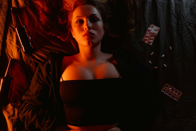 a woman laying on top of a bed next to a guitar, an album cover, inspired by Nan Goldin, unsplash, digital art, elizabeth olsen as scarlet witch, high red lights, holding hot sauce, portrait sophie mudd