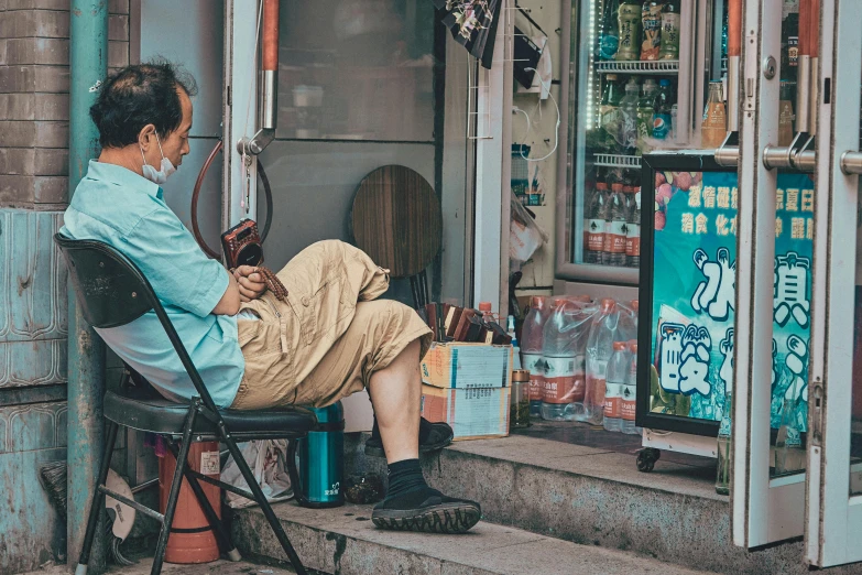 a man sitting on a chair in front of a store, pexels contest winner, big trouble in little china, convenience store, an oldman, smoking outside