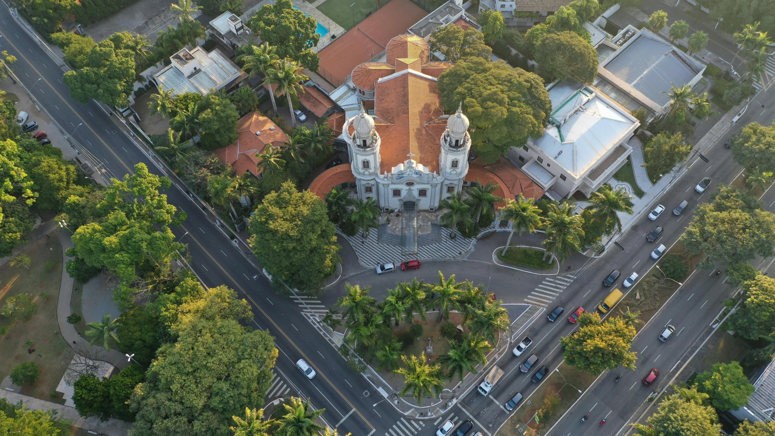 an aerial view of a church surrounded by trees, renaissance, tropical coastal city, square, high res 8k, fan favorite