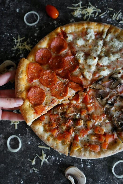 a pizza sitting on top of a table covered in toppings, a portrait, by Robbie Trevino, unsplash, hands, split in half, ultra textured, thumbnail