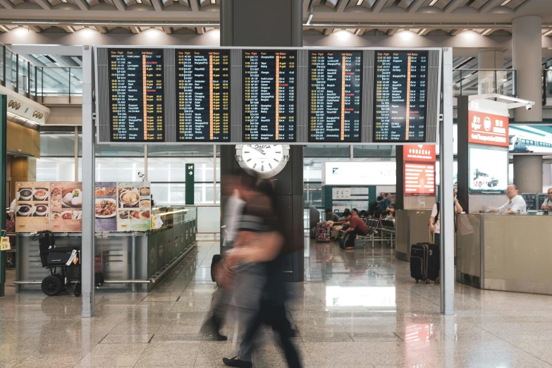 a couple of people that are walking in a building, crowded airport, led displays, thiago lehmann, whirling gasses