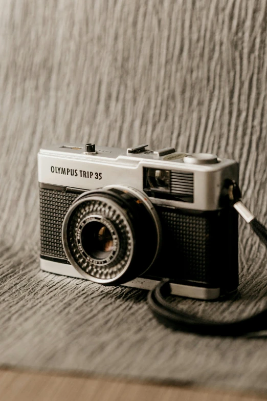 a black and white photo of a camera, unsplash contest winner, photorealism, olympus, photographed on colour film, grey metal body, tourist