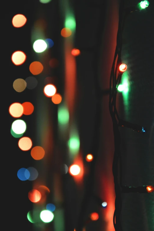 a close up of a traffic light on a pole, pexels, light and space, festive, paul barson, fairy lights, red green black teal