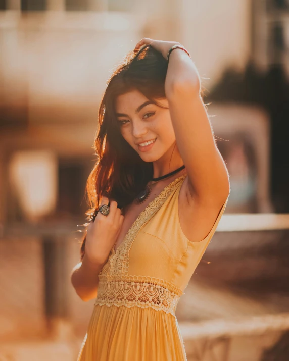 a woman in a yellow dress posing for a picture, trending on pexels, happening, golden hour 8k, tan skin, smiling :: attractive, instagram picture