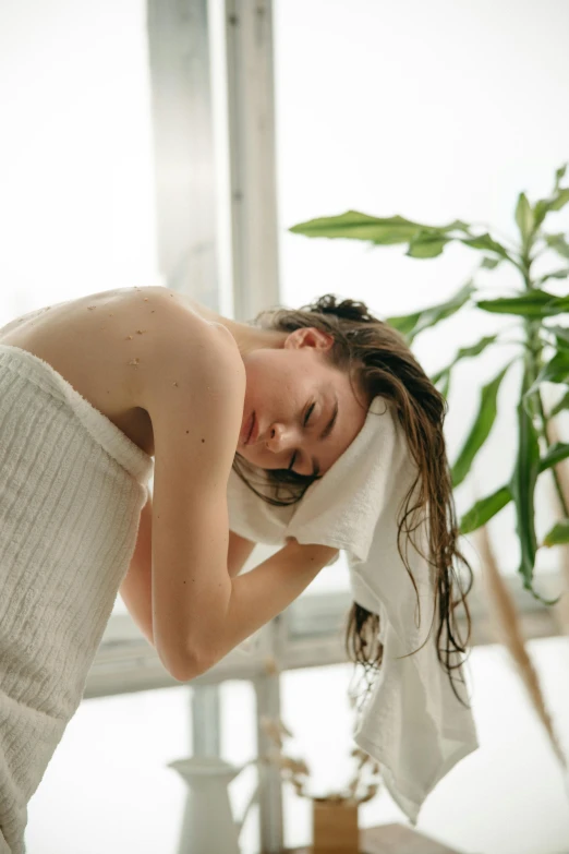 a woman laying on top of a bed covered in a towel, inspired by Elsa Bleda, trending on pexels, renaissance, scratching head, disappointed, botanical, under a shower