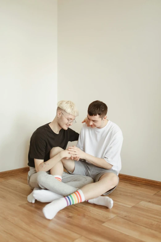 a man and a woman sitting on the floor, trending on pexels, lgbt, very pale, taejune kim, high quality photo