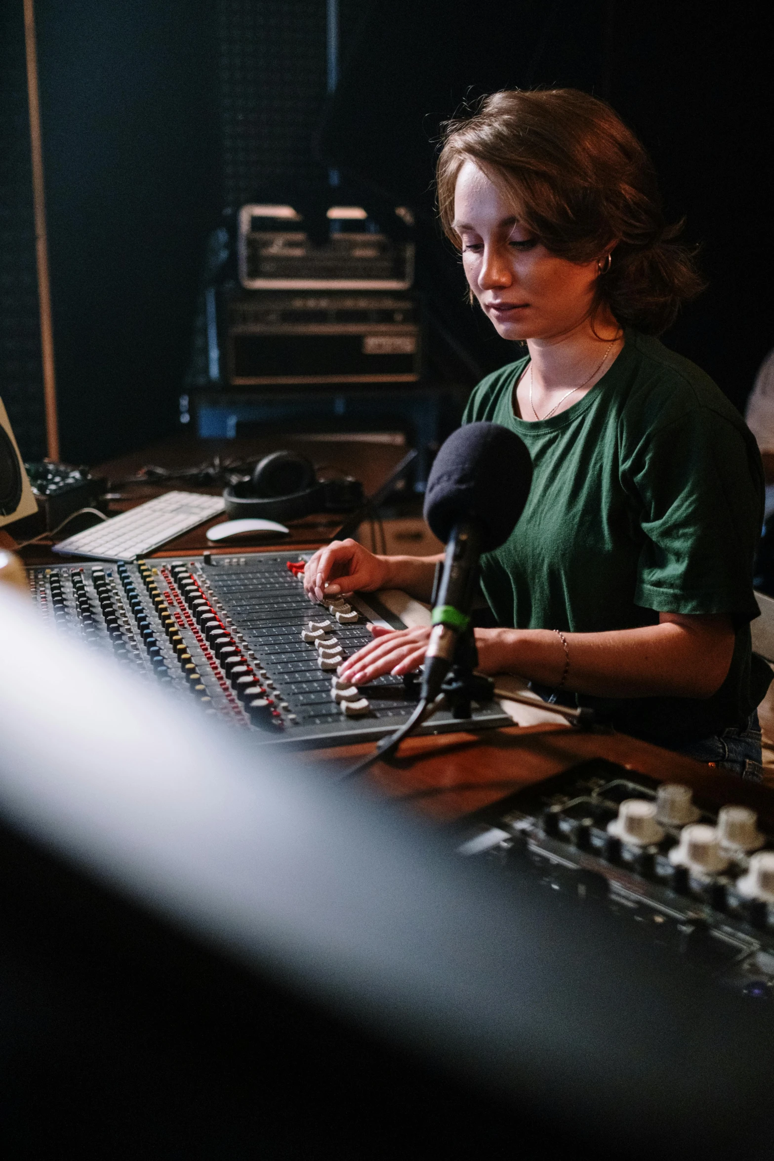 a woman sitting at a mixing desk in a recording studio, pexels, happening, portrait of sanna marin, lachlan bailey, radio signals, heath clifford