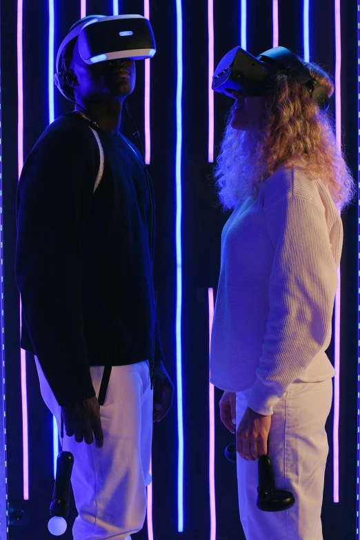 a couple of men standing next to each other, pexels, video art, white neon lighting, male and female, young thug, a blond