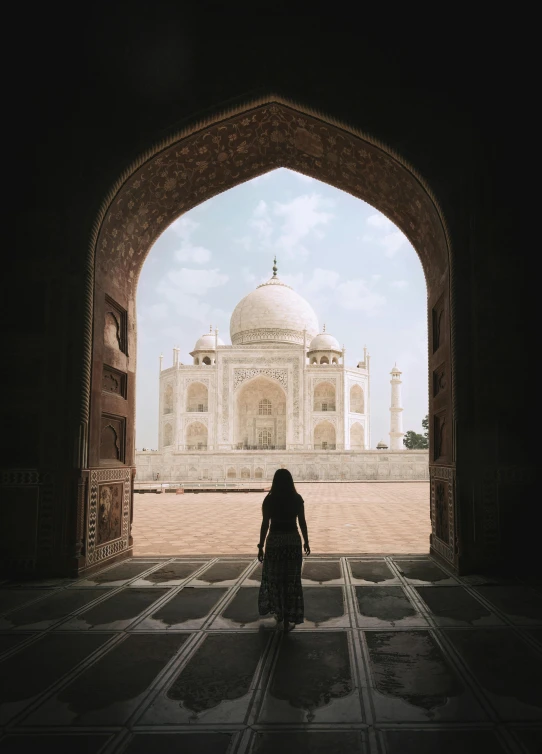 a woman standing in the doorway of a building, inspired by Steve McCurry, pexels contest winner, renaissance, taj mahal made of cheese, square, view from inside, ( ( theatrical ) )