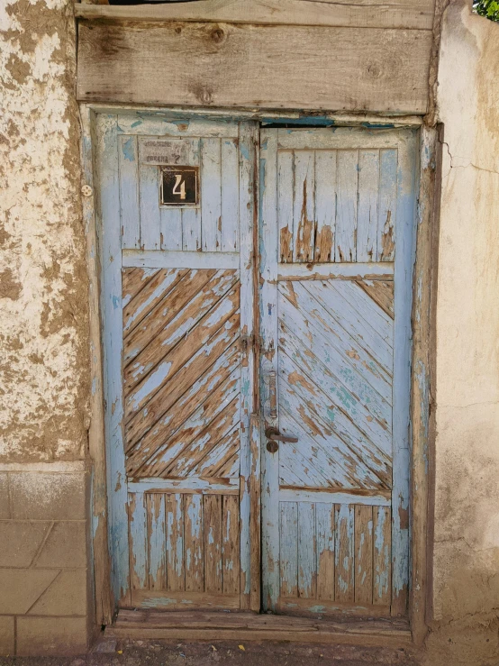 a blue door that is on the side of a building, an album cover, weathered olive skin, ((blue)), numerical, 4 colors