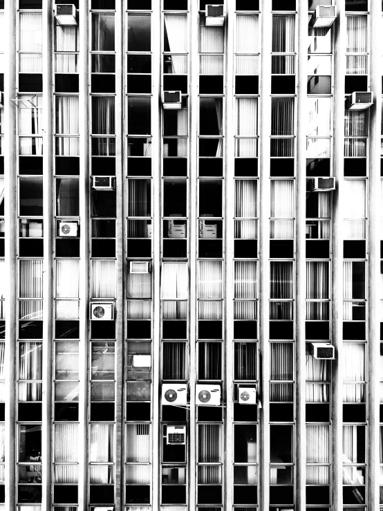 a black and white photo of a tall building, a photocopy, inspired by Andreas Gursky, unsplash, brutalism, air conditioner, house windows, ffffound, square shapes