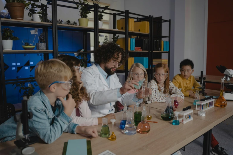 a group of people sitting around a wooden table, science, avatar image, scientific glassware, kids