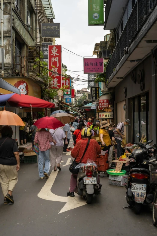 a group of people walking down a street with umbrellas, like jiufen, riding a motorbike down a street, people shopping, brown