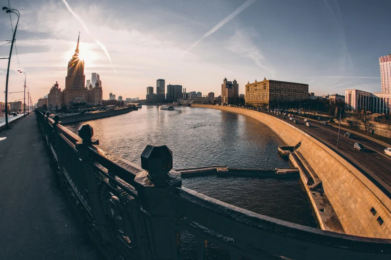 a bridge over a river with buildings in the background, pexels contest winner, socialist realism, gta in moscow, panoramic, 000 — википедия, golden hour