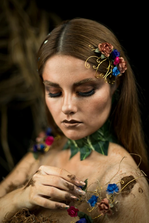 a close up of a woman with flowers in her hair, a portrait, inspired by Wendy Froud, trending on pexels, gold bodypaint, wearing a dress made of vines, 5 0 0 px models, model posing