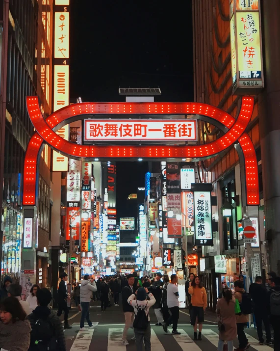 a group of people walking down a street next to tall buildings, a photo, trending on unsplash, ukiyo-e, neon sign, electricity archs, 2 0 0 0's photo, local illumination