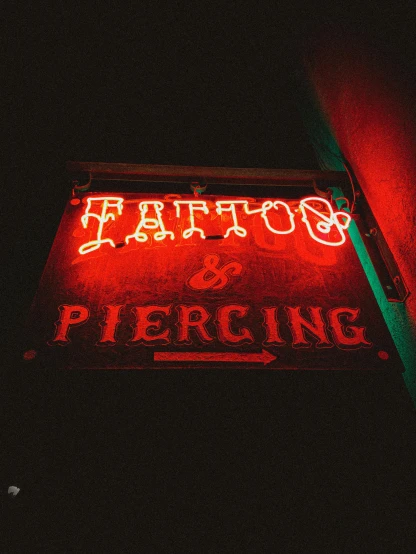 a neon sign on the side of a building, a tattoo, trending on pexels, earring, poster cover art, stitches, peter palombi