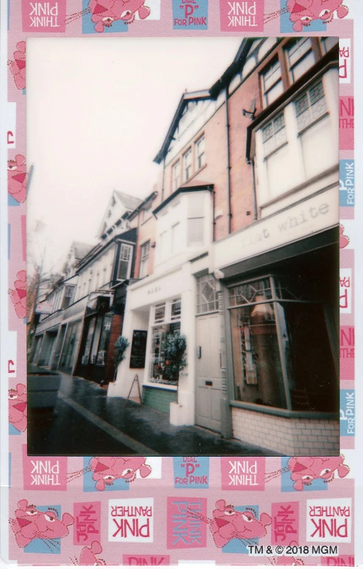 a polaroid picture of a woman walking down a street, a polaroid photo, private press, house's and shops and buildings, dreamy aesthetic, wales, shop front