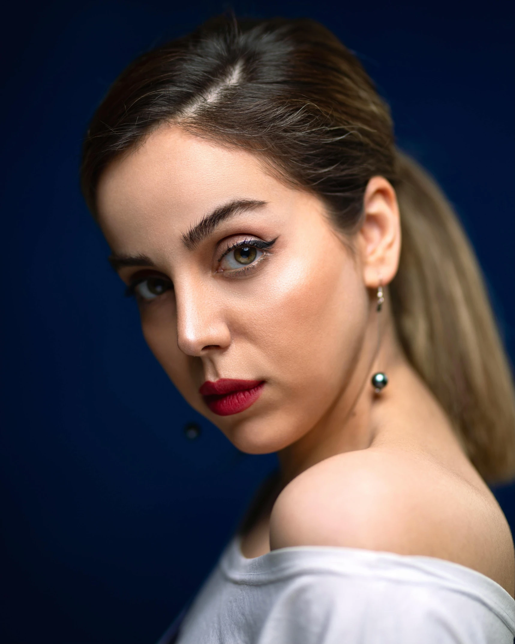 a woman in a white top posing for a picture, inspired by Elsa Bleda, trending on pexels, photorealism, charli xcx, wearing professional makeup, blue and red tones, photo taken with sony a7r