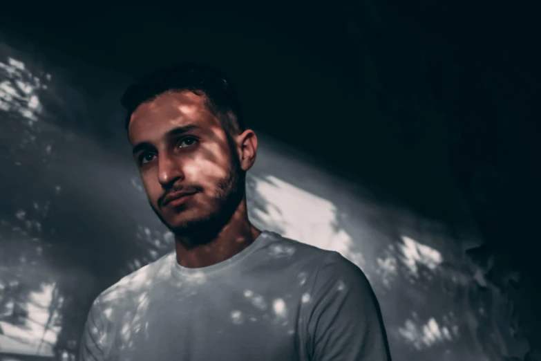 a man standing in front of a wall, a portrait, pexels contest winner, antipodeans, shaded lighting, halfbody headshot, sam nassour, a still of an ethereal