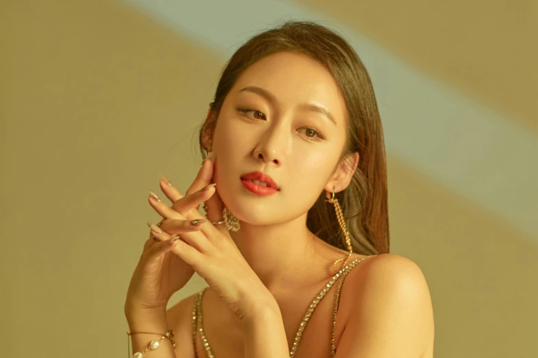 a woman in a gold dress posing for a picture, an album cover, inspired by Sim Sa-jeong, trending on pexels, earring, krystal, square, 4k)