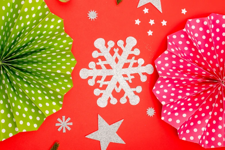 a group of paper snowflakes sitting on top of a red surface, trending on pexels, pop art, background image, polka dot tables, multi - coloured, ad image