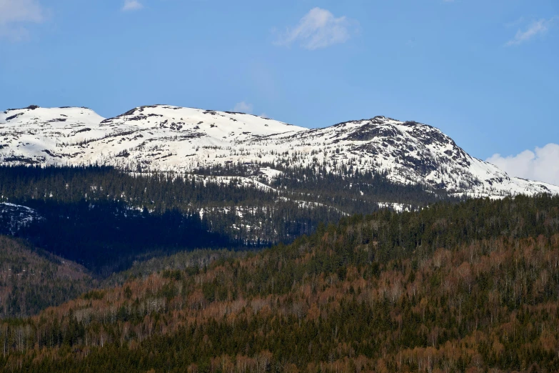 a plane flying over a mountain covered in snow, a picture, hurufiyya, new hampshire mountain, thumbnail, during spring, nordic crown