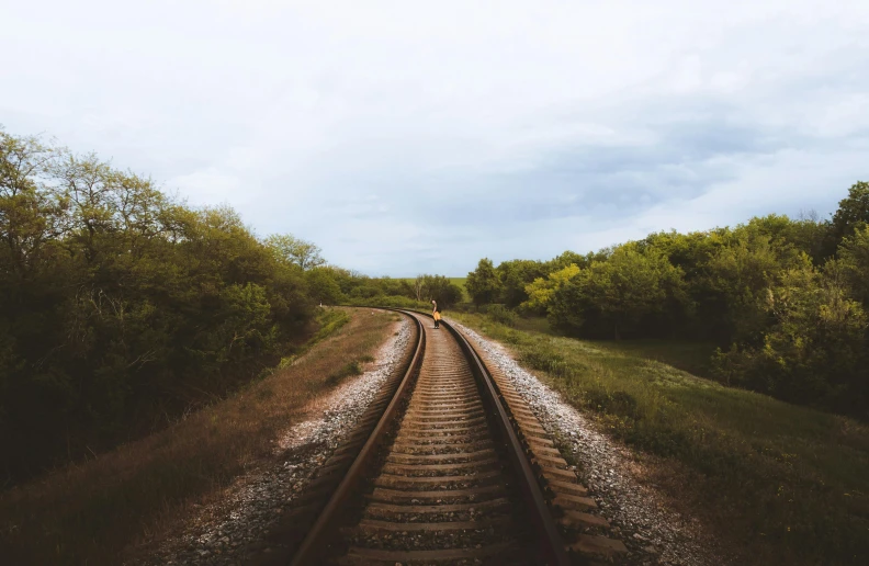 a train track in the middle of a field, pexels contest winner, over the shoulder, trending on vsco, lush scenery, platforms