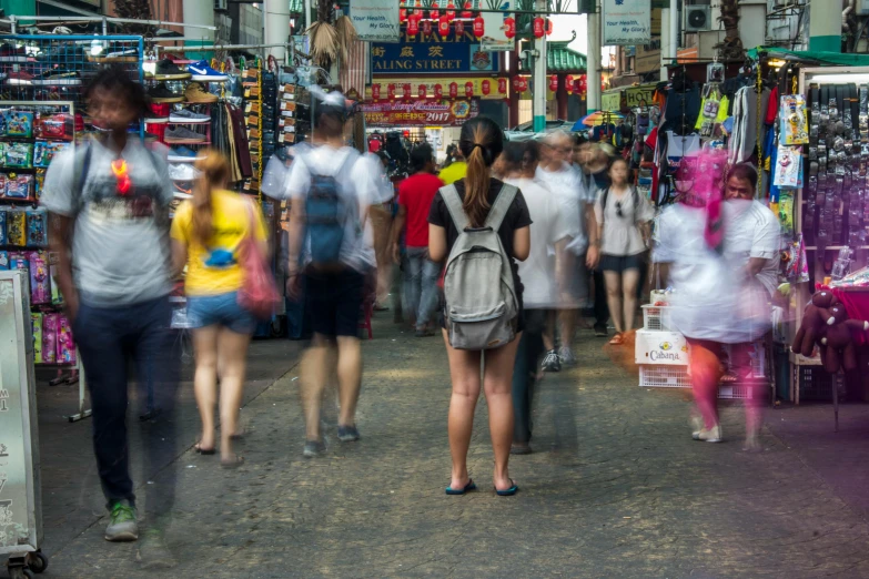 a group of people walking down a street, by Reuben Tam, pexels contest winner, wet market street, avatar image, female looking, pixelated