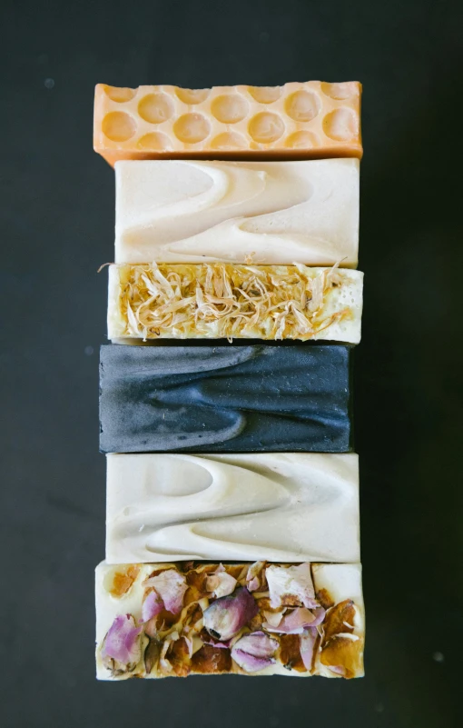 four soap bars stacked on top of each other, by Jessie Algie, dark and white, thumbnail, seasonal, long