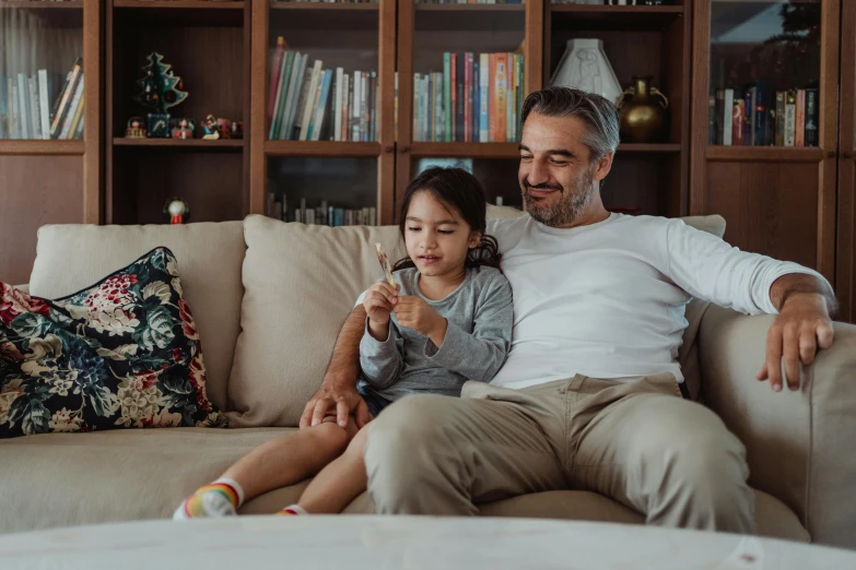 a man and a little girl sitting on a couch, pexels contest winner, avatar image, tv series, finger, lifestyle