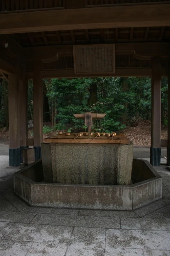 a gazebo with a fountain in the middle of it, inspired by Itō Jakuchū, unsplash, sōsaku hanga, 2 5 6 x 2 5 6 pixels, ritual in a forest, watertank, brown