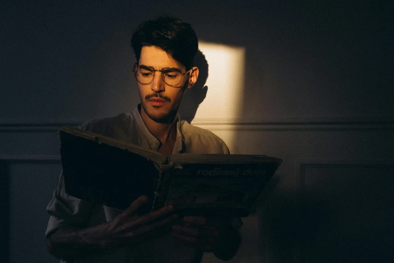 a man reading a book in the dark, pexels contest winner, hyperrealism, with glasses and goatee, full daylight, instagram post, light stubble