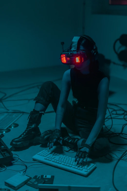 a person sitting on the floor with a keyboard and headphones, cyberpunk art, video art, wearing vr goggles, motion capture system, eyes projected onto visor, tense