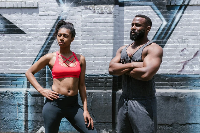 a man and a woman standing next to each other, wearing fitness gear, mc ride, profile image, serious composure