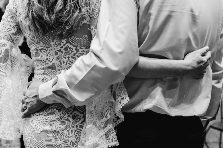 a man and a woman standing next to each other, a black and white photo, by Emma Andijewska, pexels, dressed in a frilly ((lace)), hugging each other, man grabbing a womans waist, finer details : 3