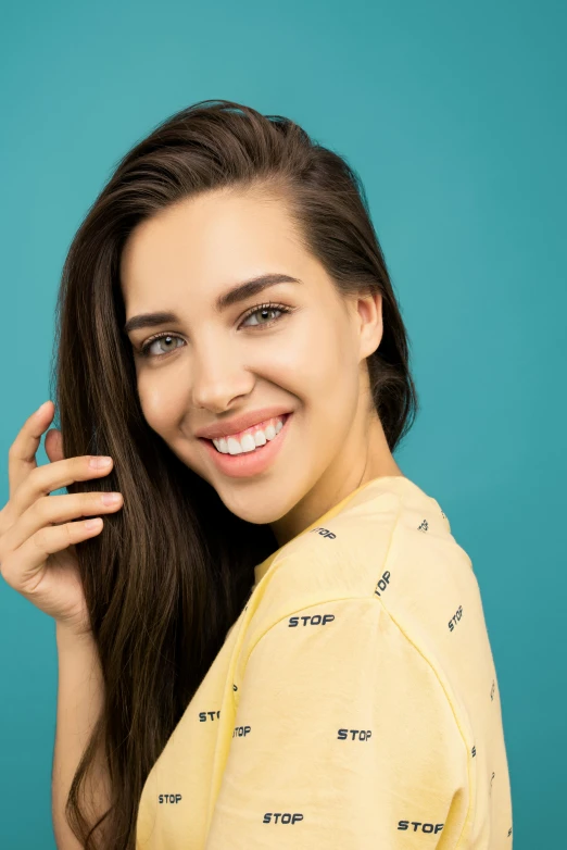 a woman in a yellow shirt smiles at the camera, by Julia Pishtar, trending on pexels, turqouise, photoshoot for skincare brand, frontal pose, maximum detail