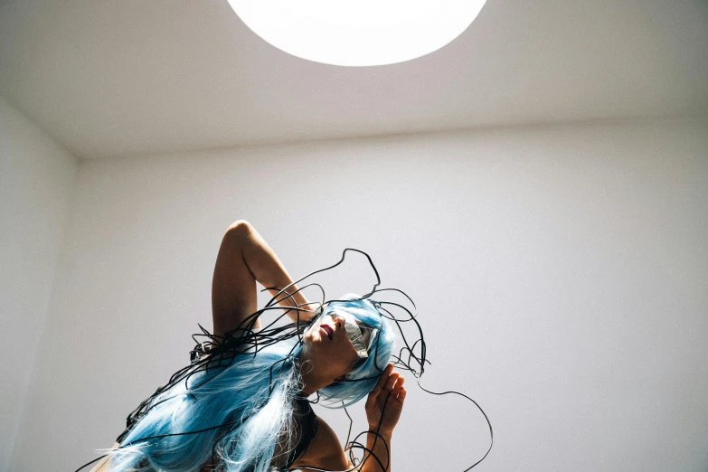 a woman with blue hair laying on a bed, inspired by Shigeru Aoki, unsplash, light and space, featuring wires, jelly fish dancing, skylight open ceiling, in a white room