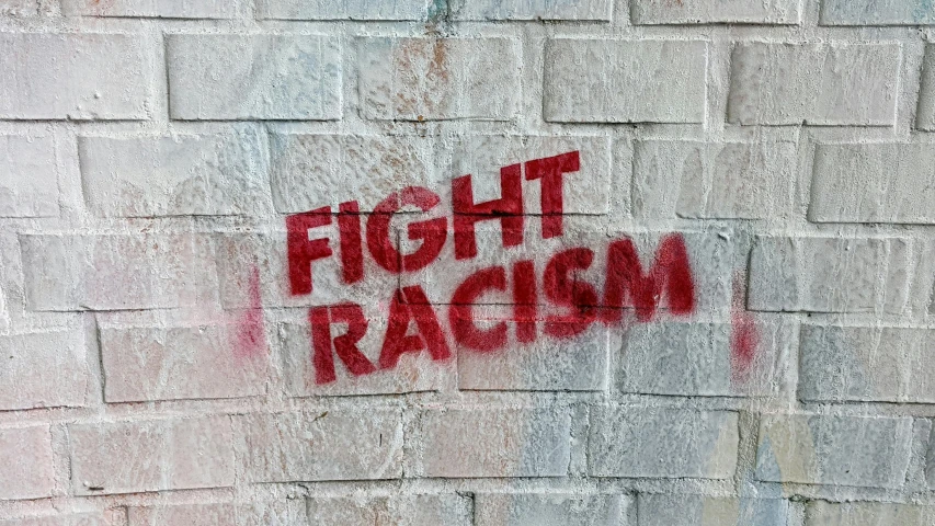 a red fire hydrant sitting in front of a brick wall, an album cover, graffiti, raised fist, gradient brown to white, close-up fight, black - and - white photograph