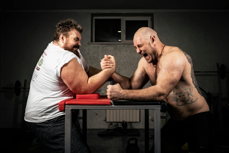 two men are arm wrestling in a gym, a portrait, by Adam Marczyński, pexels contest winner, private press, action bronson, square, szekely bertalan and lotz karoly, profile image