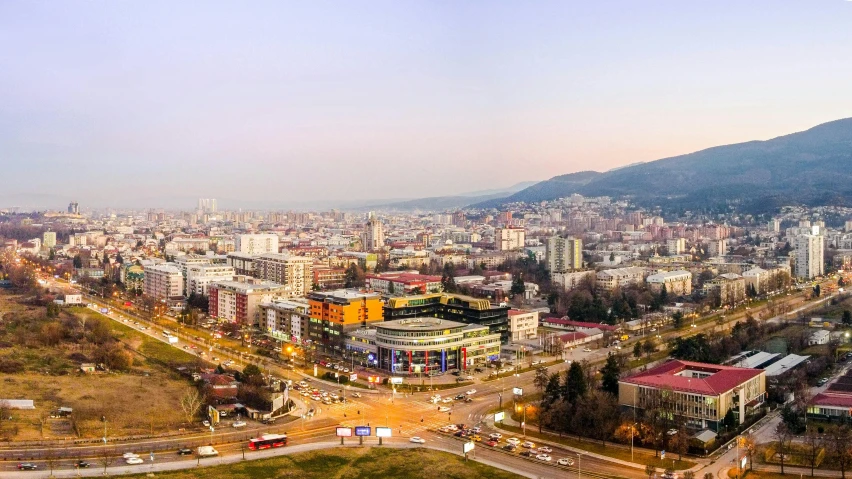 an aerial view of a city with mountains in the background, by Arthur Sarkissian, pexels contest winner, panoramic widescreen view, square, romanian, full building