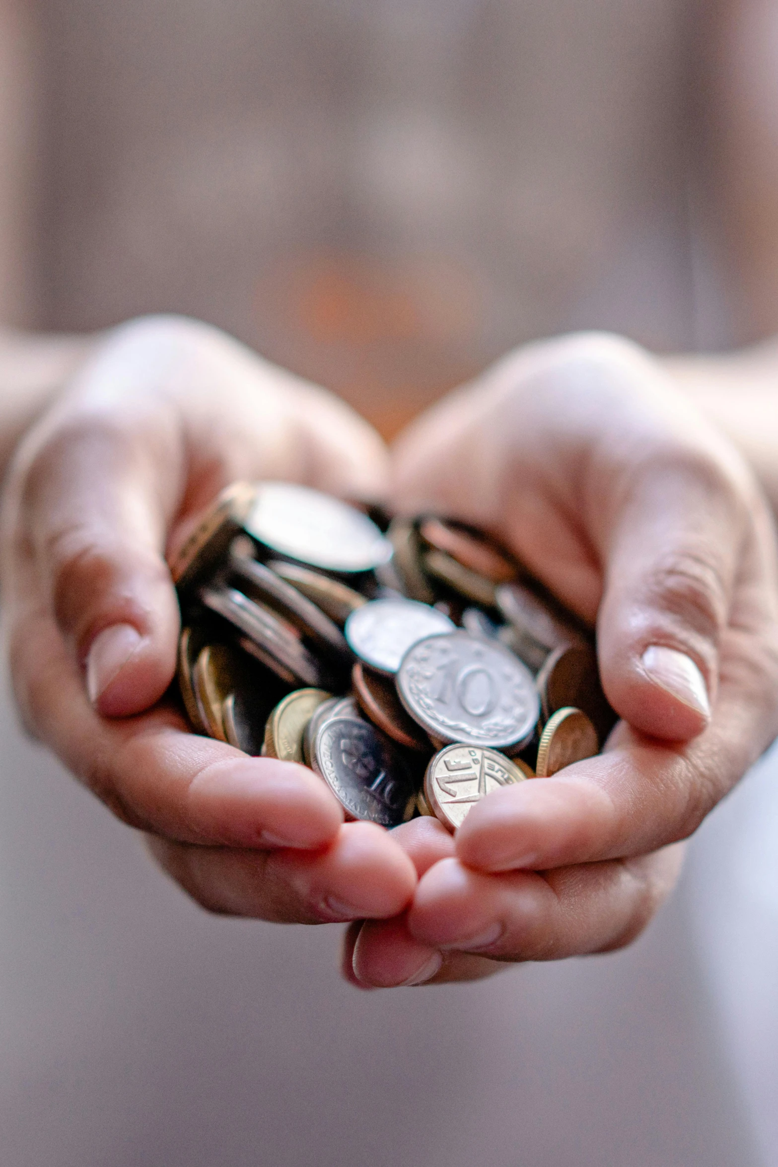 a person holding a bunch of coins in their hands, pexels contest winner, loosely cropped, promo image, hands pressed together in bow, alter