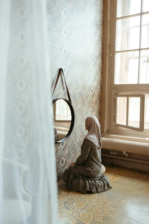 a statue of a woman sitting in front of a window, a picture, unsplash contest winner, arabesque, hijab, mirror, demur, fabrics and textiles