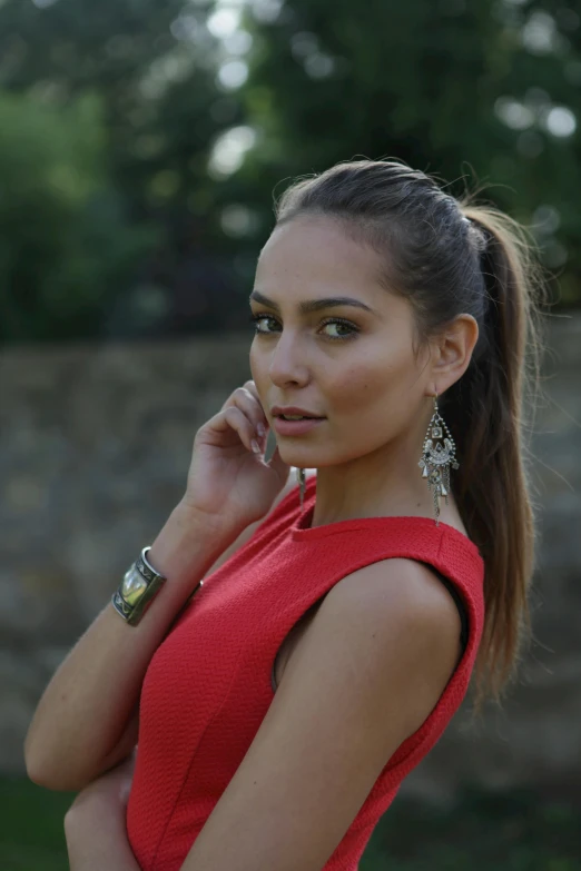 a woman in a red dress talking on a cell phone, hair in slick low ponytail, anastasia ovchinnikova, headshot half figure, olive skin