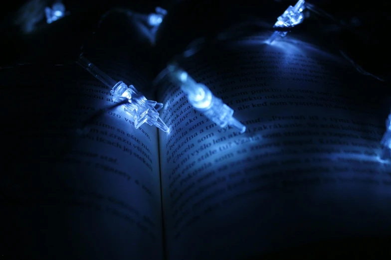 a close up of a book with lights on it, blue, modeled, string lights, high quality wallpaper