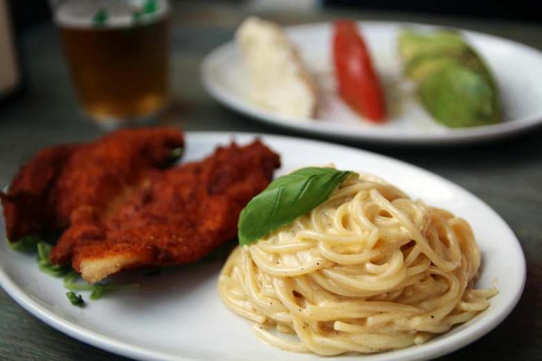 a close up of a plate of food on a table, served with pasta, very detailed »