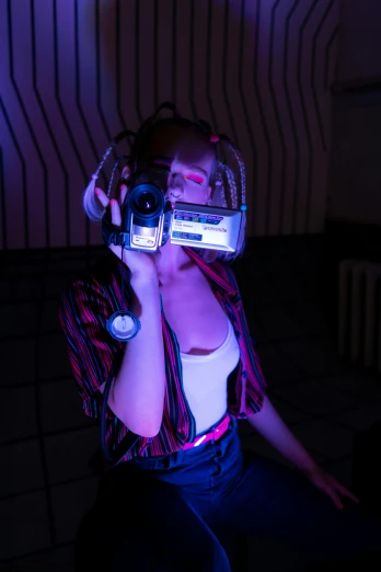 a woman holding a camera up to her face, a hologram, y 2 k cybercore, low light room, with headphones, 8 0 s camera