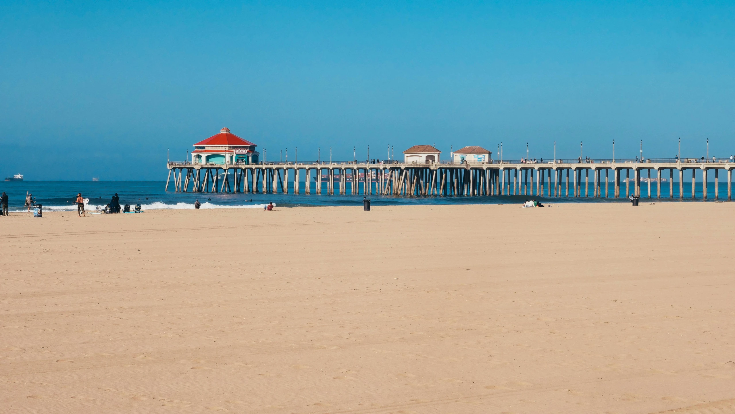 a man flying a kite on top of a sandy beach, by Jacob Burck, pexels contest winner, renaissance, wood pier and houses, square, frank gehry, california;