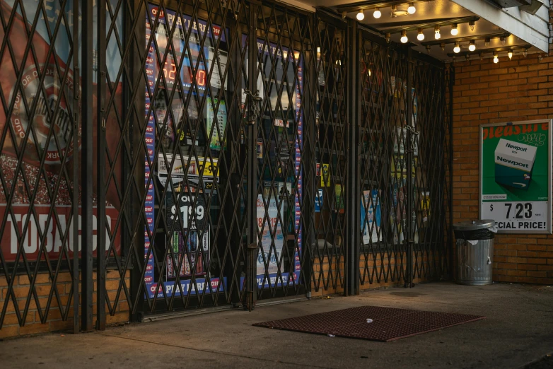 a red fire hydrant sitting in front of a store, an album cover, by Dennis Flanders, pexels contest winner, temporary art, massive decorated doors, cell bars, panoramic shot, taco bell